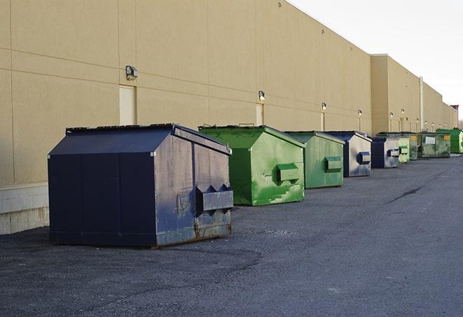 multiple dumpsters lining a construction site in Andale